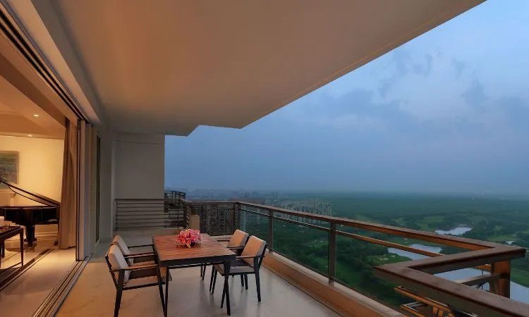 Private balcony with evening skyline view at DLF Privana North